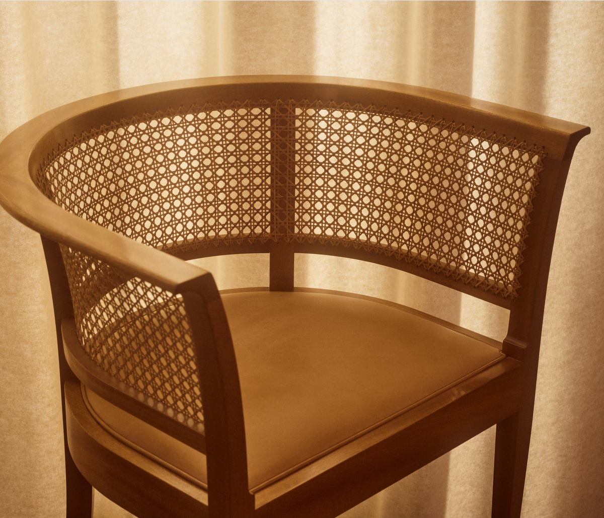 The Beauty Sleeper editorial featuring the Faaborg Chair in warm wood and woven cane against softly lit curtains.
