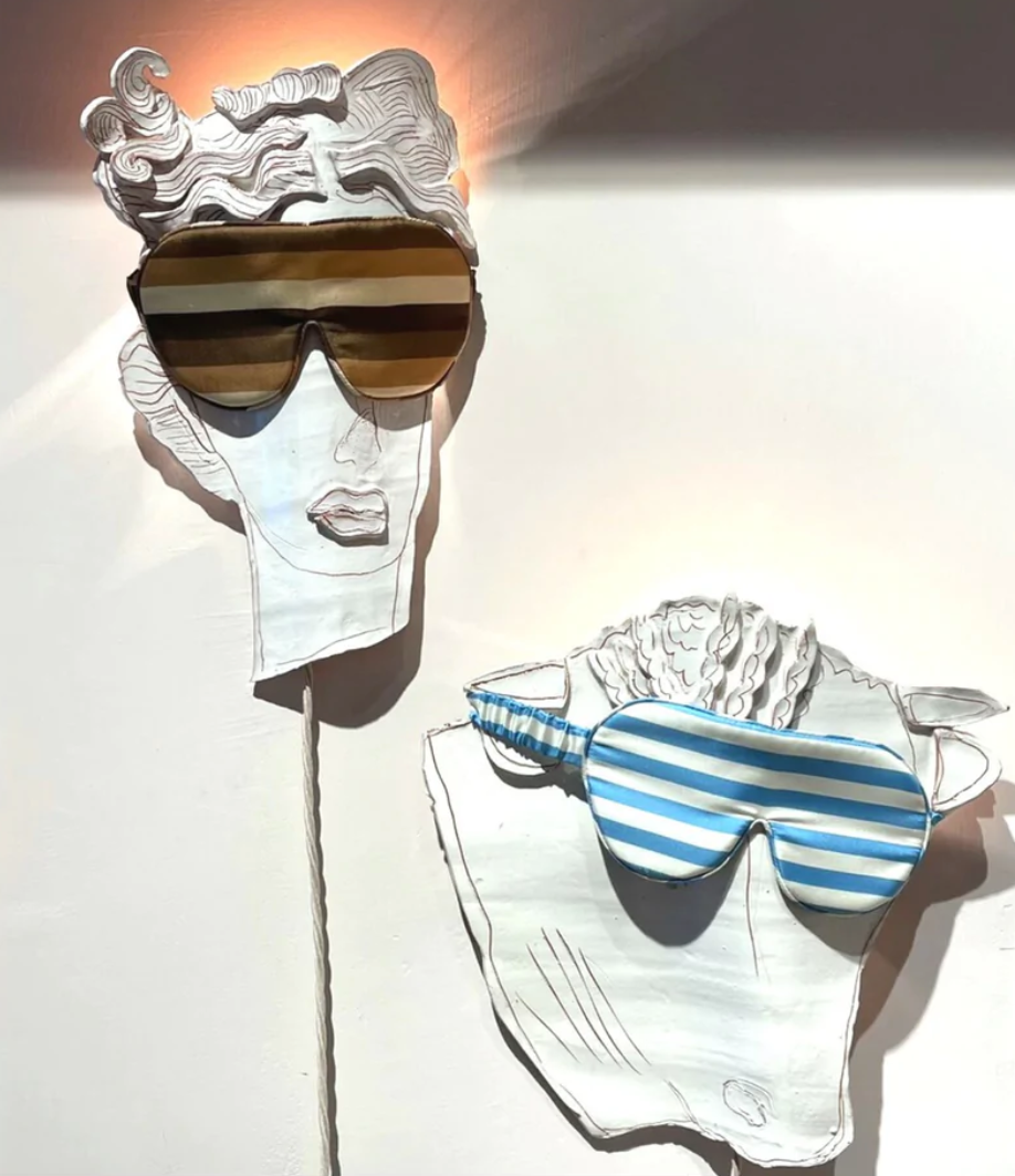 The Beauty Sleeper Lepus and Pisces silk sleep masks displayed on illustrated faces at Holly Golightly in Copenhagen.